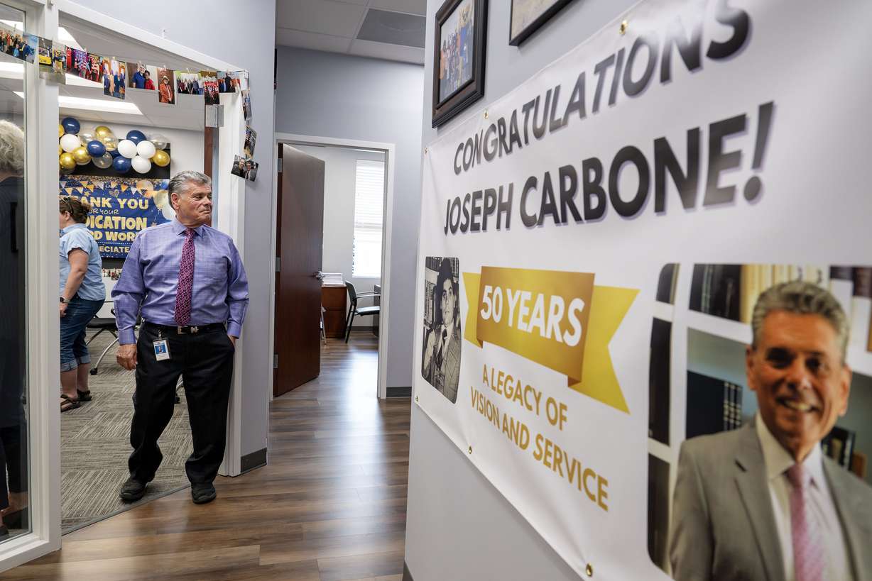 Outgoing president and CEO Joseph Carbone of EyeCare4Kids looks around at a banner and other areas during a community open house. The event celebrated leadership transitions and reintroduced the community to the organization, which has been helping children in Utah see better since 2001. It was held in Midvale on Monday. (Photo: Scott G Winterton, Deseret News)
